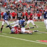Blue player tackling a red player.